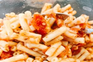 close up of stewed tomatoes and macaroni noodles