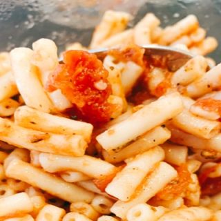 close up of stewed tomatoes and macaroni noodles