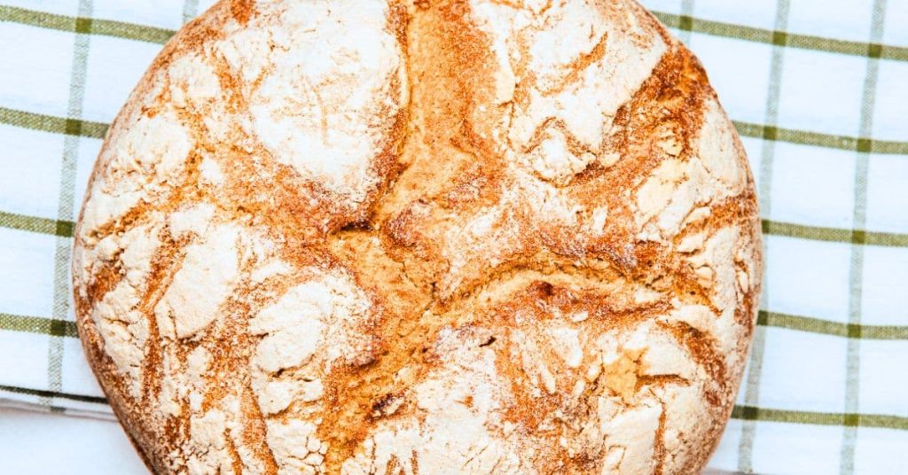 Homemade Sourdough Bread Recipe Homemade Sourdough Bread Recipe with sourdough starter on a striped dish towel on a counter